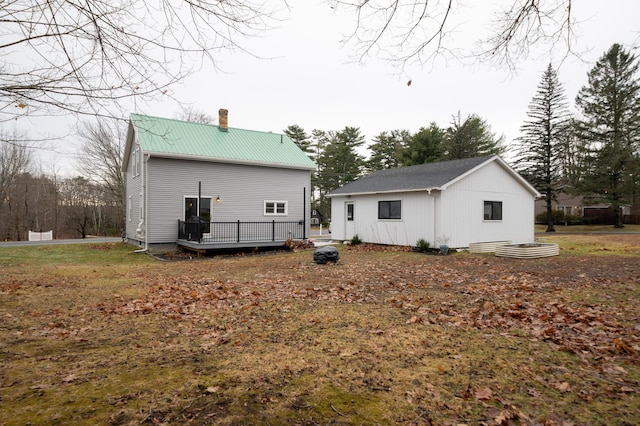 back of house featuring a wooden deck