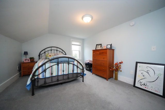 carpeted bedroom with lofted ceiling