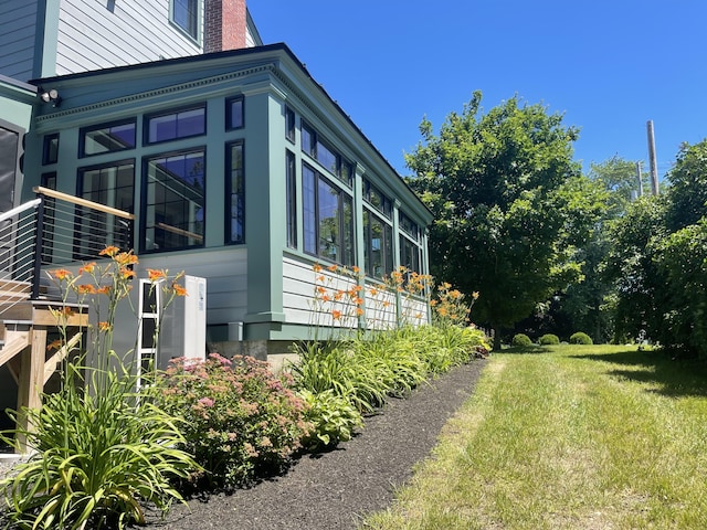 102 Main St, Belgrade, ME 04917 - view of side of home featuring a sunroom and a yard