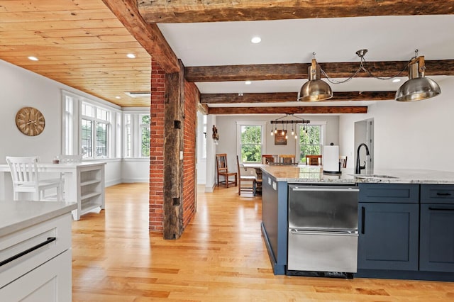 102 Main St, Belgrade, ME 04917 - kitchen with beam ceiling, light stone countertops, and light hardwood / wood-style flooring
