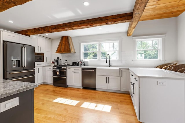 102 Main St, Belgrade, ME 04917 - kitchen with white cabinets, sink, beamed ceiling, and stainless steel appliances