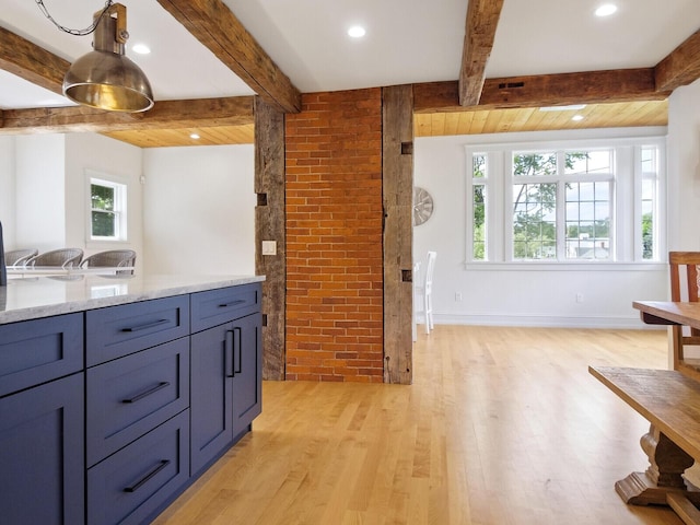 102 Main St, Belgrade, ME 04917 - kitchen with beamed ceiling, light hardwood / wood-style flooring, brick wall, and light stone counters