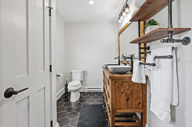 102 Main St, Belgrade, ME 04917 - bathroom with vanity, toilet, and a baseboard heating unit