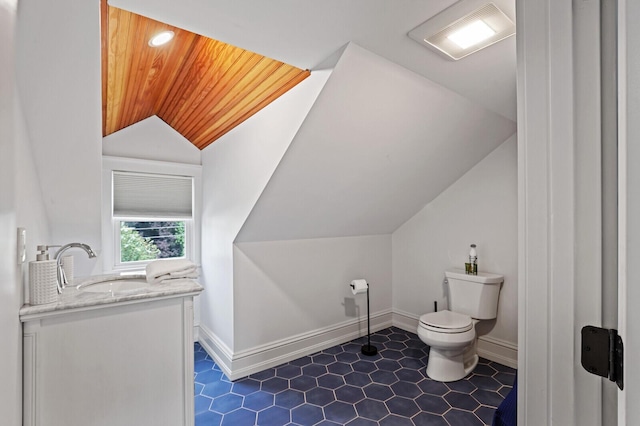 102 Main St, Belgrade, ME 04917 - bathroom with vanity, wooden ceiling, toilet, and lofted ceiling