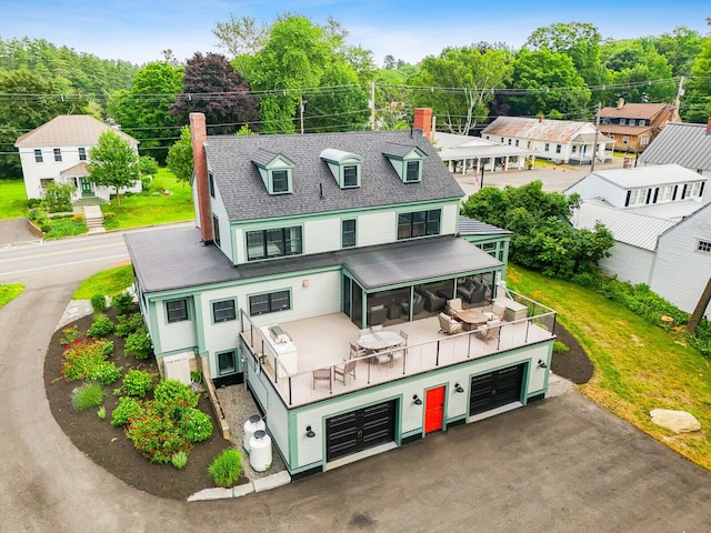 102 Main St, Belgrade, ME 04917 - back of property with a yard, a balcony, and a garage