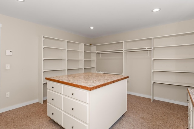 spacious closet featuring light carpet