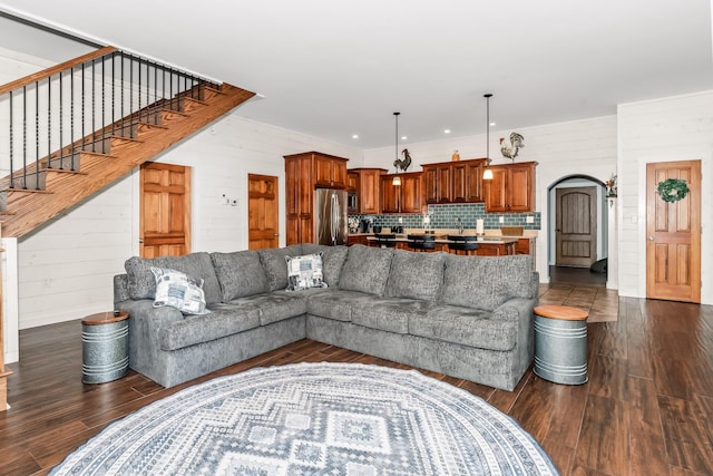 living room with wooden walls and dark hardwood / wood-style flooring