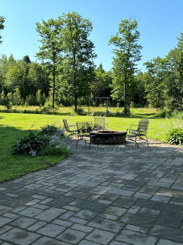 surrounding community with a lawn and a patio area