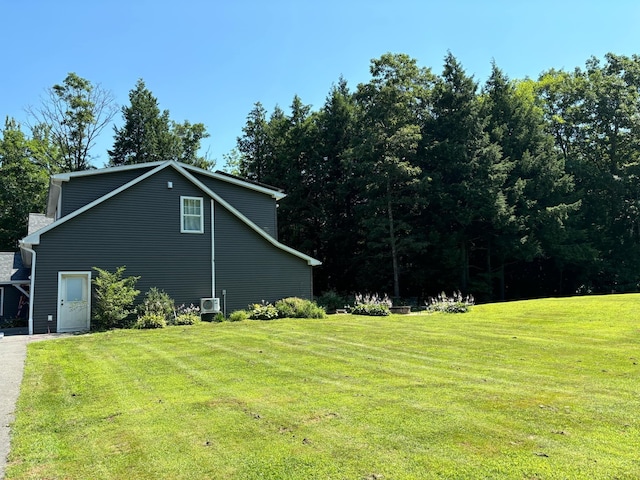 view of side of home with a lawn