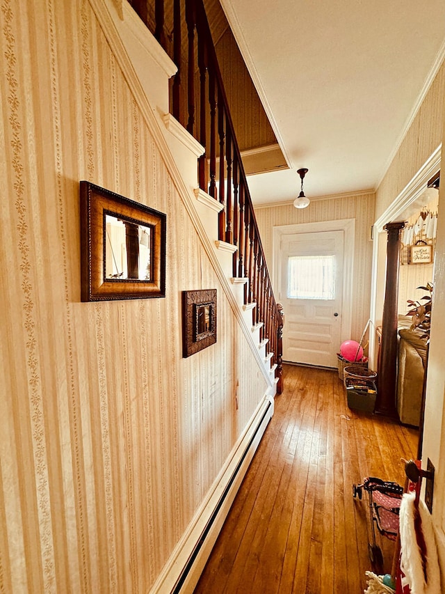 hall featuring ornamental molding and hardwood / wood-style flooring