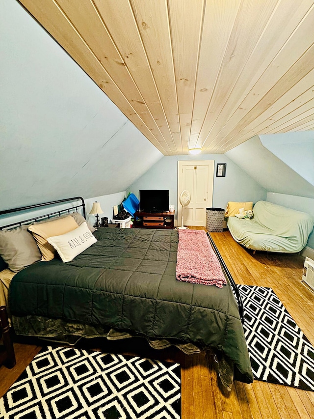 bedroom featuring vaulted ceiling, wooden ceiling, and hardwood / wood-style flooring