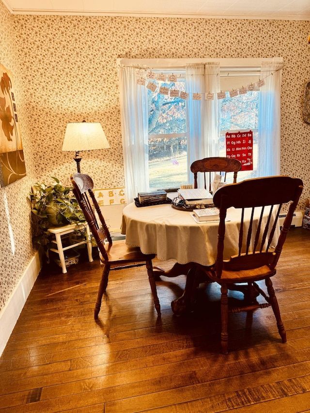 dining room with plenty of natural light, hardwood / wood-style floors, and ornamental molding