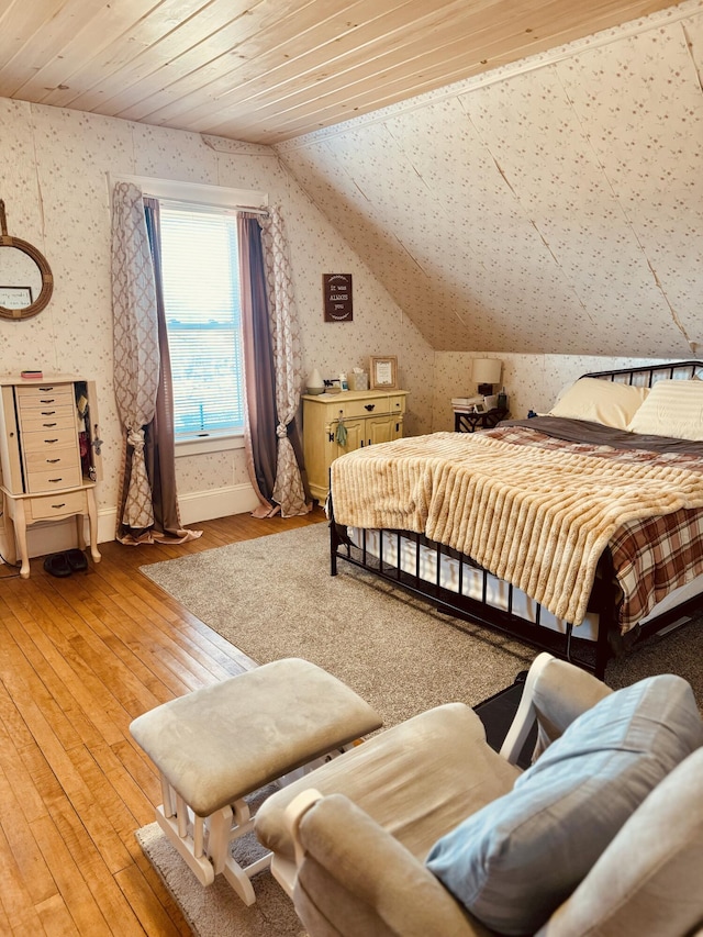 bedroom with lofted ceiling, wood-type flooring, and wooden ceiling