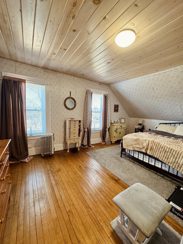 bedroom with wood-type flooring, radiator heating unit, wood ceiling, and vaulted ceiling