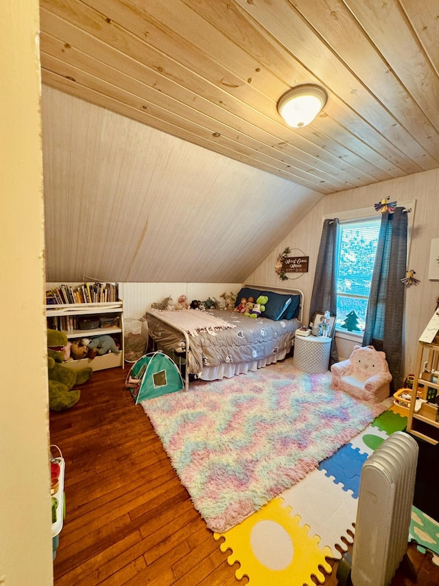 bedroom with vaulted ceiling, wooden ceiling, hardwood / wood-style flooring, and wood walls