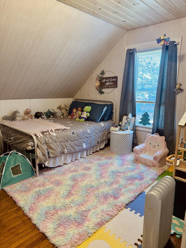 bedroom featuring vaulted ceiling and hardwood / wood-style flooring