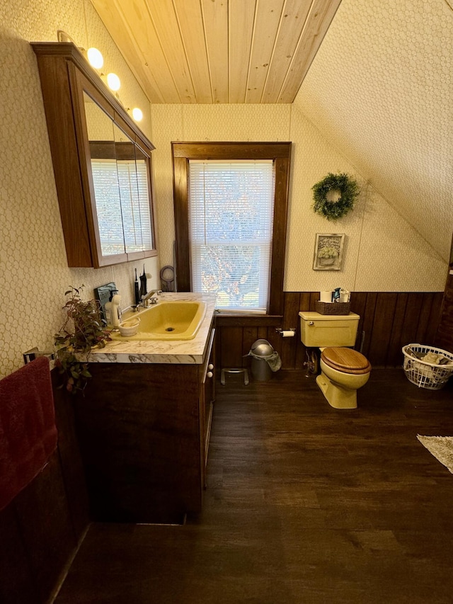 bathroom featuring toilet, plenty of natural light, hardwood / wood-style flooring, and wooden ceiling