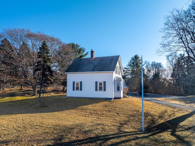 view of side of home with a yard