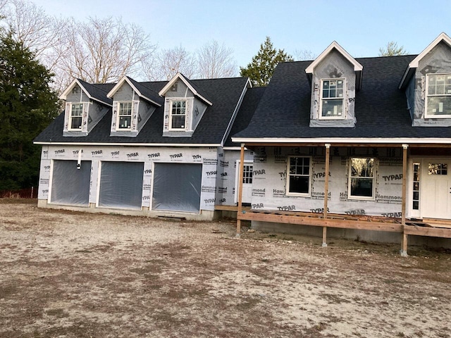 view of front of house featuring a porch and a garage