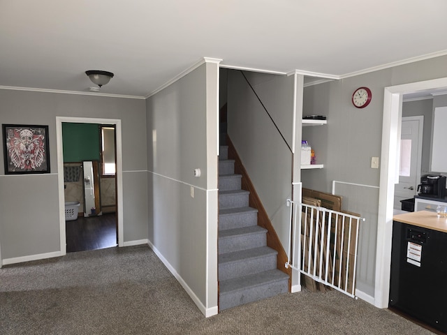 staircase with carpet floors and crown molding