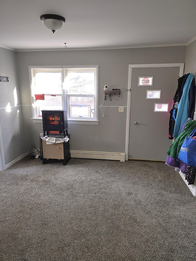 interior space featuring ornamental molding and baseboard heating