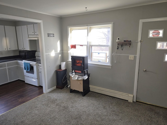 kitchen with ornamental molding, a baseboard heating unit, dark colored carpet, white electric stove, and white cabinetry