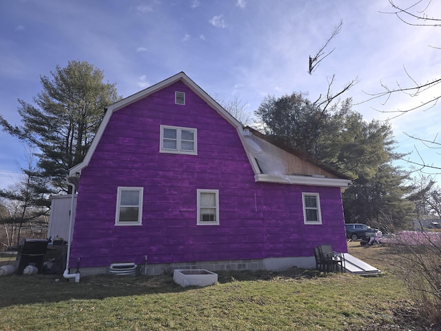 view of property exterior with a lawn