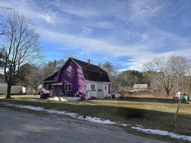 view of side of home featuring a yard