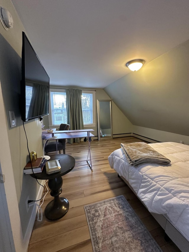 bedroom featuring lofted ceiling and hardwood / wood-style floors