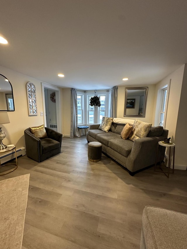 living room with hardwood / wood-style flooring and a baseboard radiator