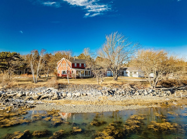 back of house with a water view