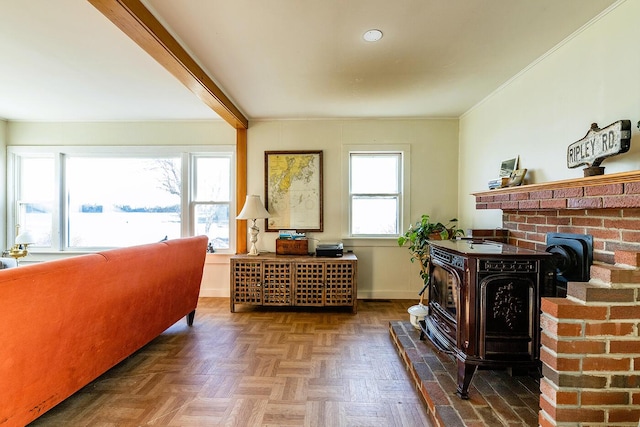 living area featuring a wood stove, beamed ceiling, a healthy amount of sunlight, and parquet flooring