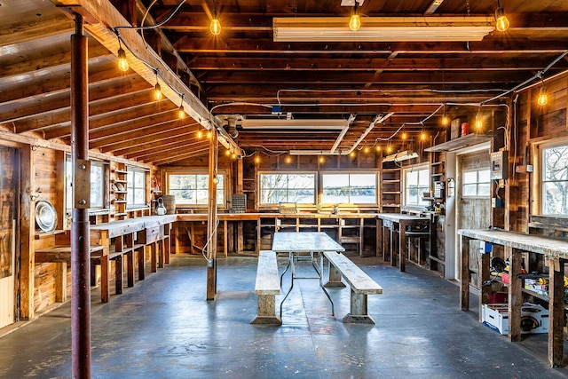 misc room featuring a workshop area, a healthy amount of sunlight, and lofted ceiling