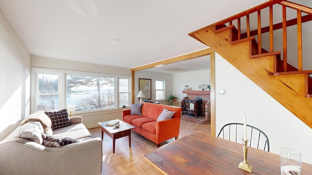 living room featuring parquet flooring and a wood stove