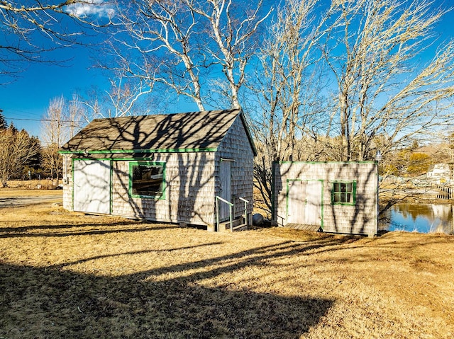 view of outbuilding featuring a water view