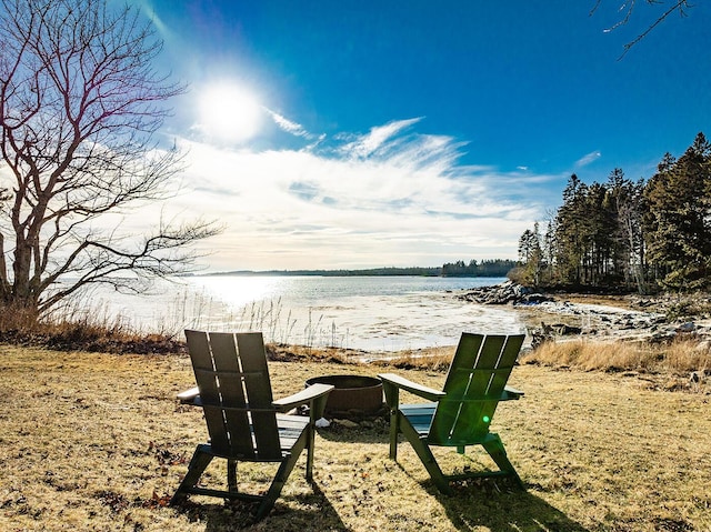 view of yard featuring a water view and an outdoor fire pit