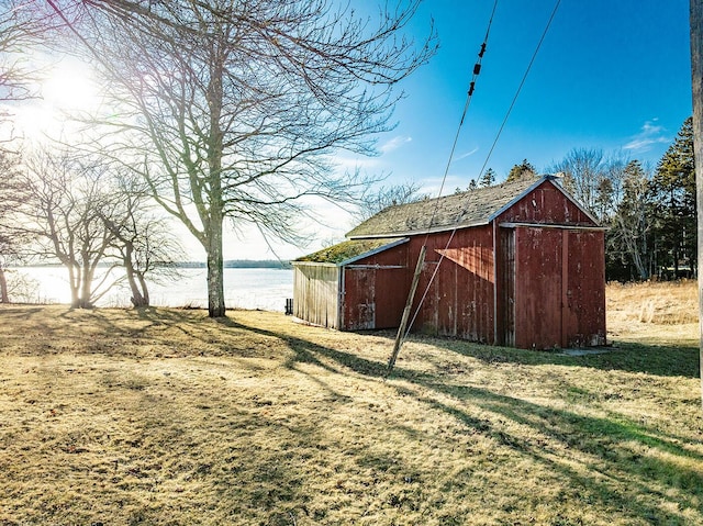 view of yard with a water view and a storage unit