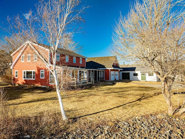 rear view of property featuring a lawn