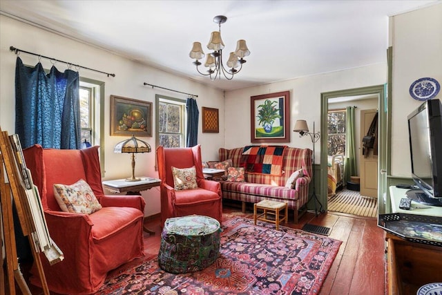 sitting room featuring hardwood / wood-style floors and a notable chandelier