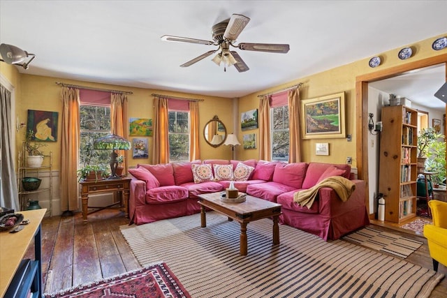 living room with dark hardwood / wood-style flooring and ceiling fan