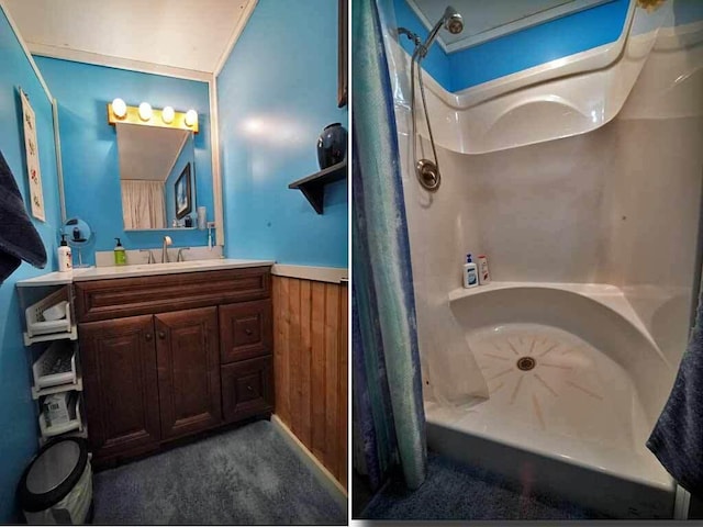 bathroom featuring a shower with curtain, wainscoting, wooden walls, and vanity