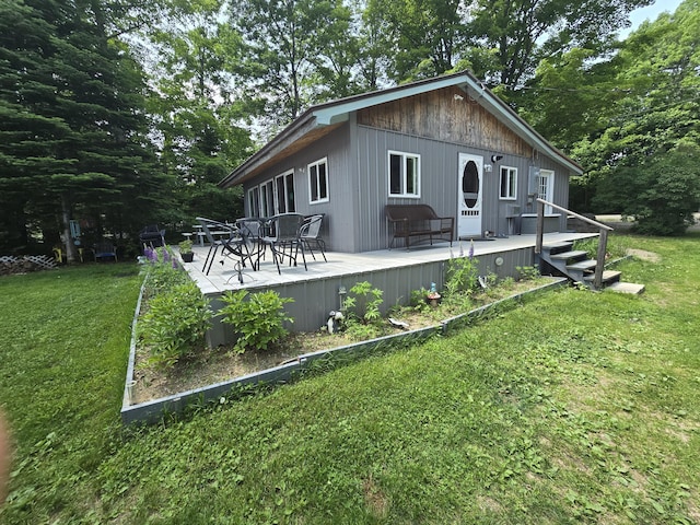 53 Calvin Ln, Oakfield, ME 04763 - view of side of property with a lawn and a wooden deck