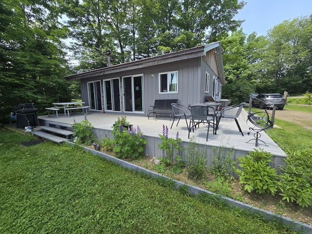 53 Calvin Ln, Oakfield, ME 04763 - back of property featuring a wooden deck, a yard, and outdoor dining space