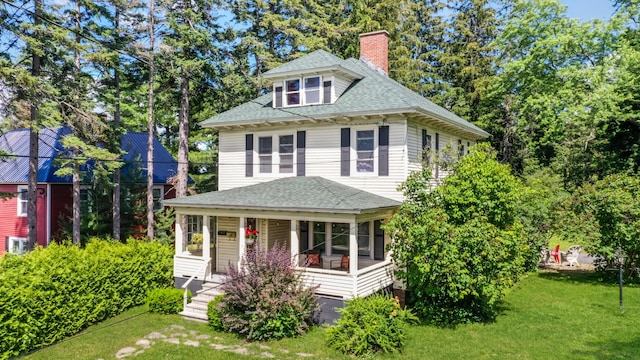 view of front of property with covered porch and a front yard