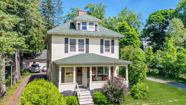 view of front facade with covered porch and a front yard