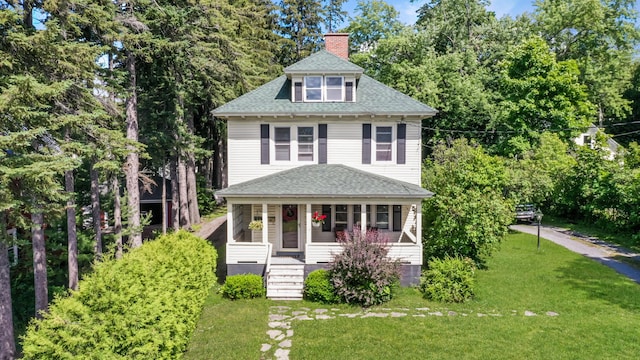 view of front of house with a front lawn and covered porch