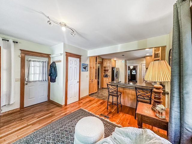 entryway with hardwood / wood-style flooring