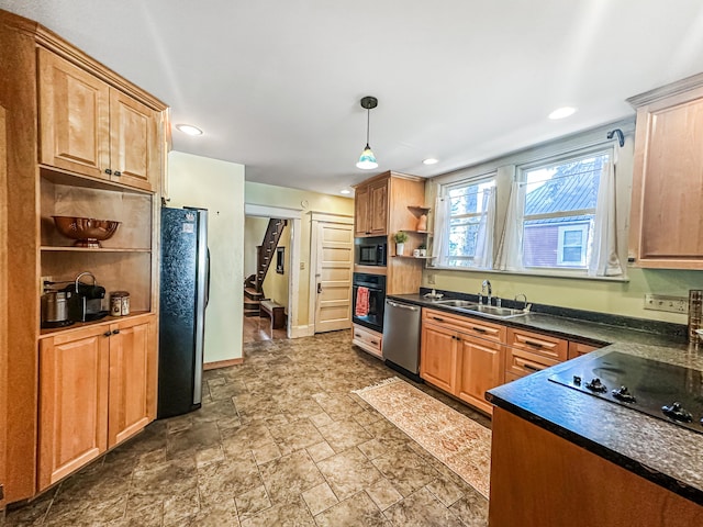 kitchen with hanging light fixtures, sink, and black appliances