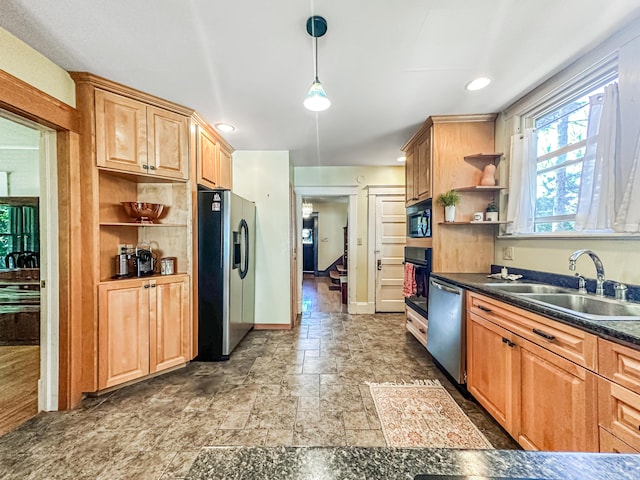 kitchen featuring sink, hanging light fixtures, and black appliances