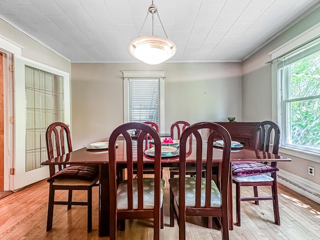 dining area featuring light hardwood / wood-style floors, plenty of natural light, and ornamental molding